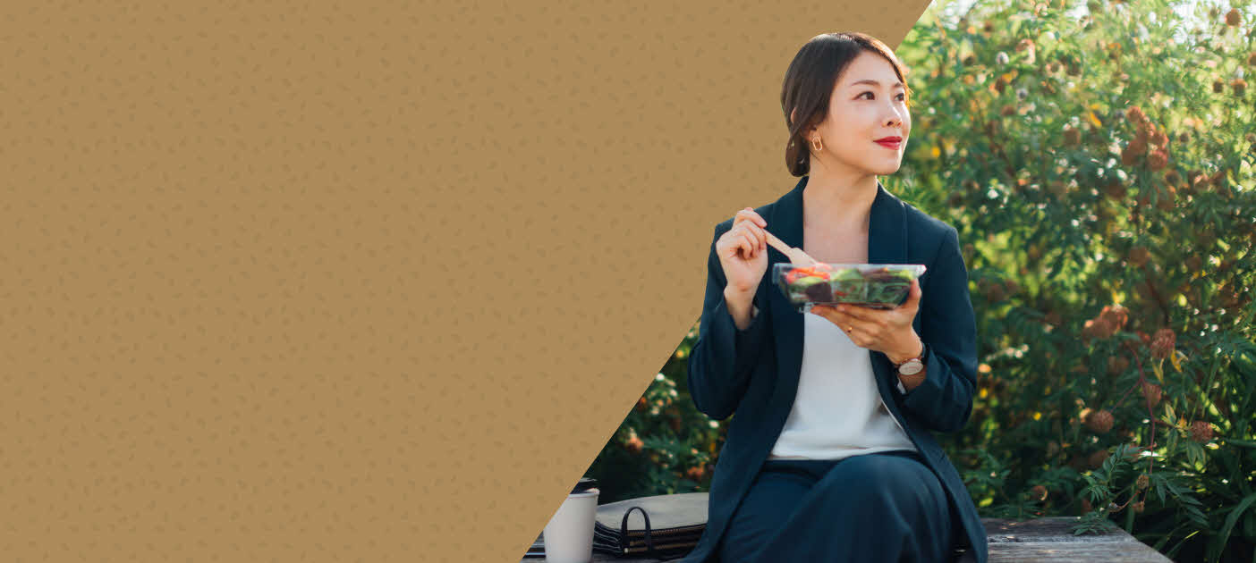 Woman enjoying her customised grain bowl, which symbolises the combination of investments and insurance.